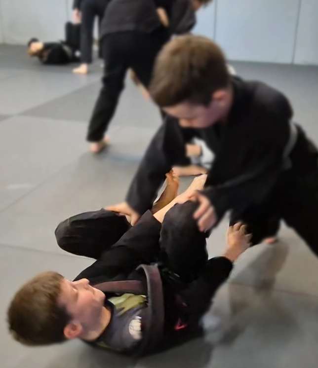 two young grapplers playing guard